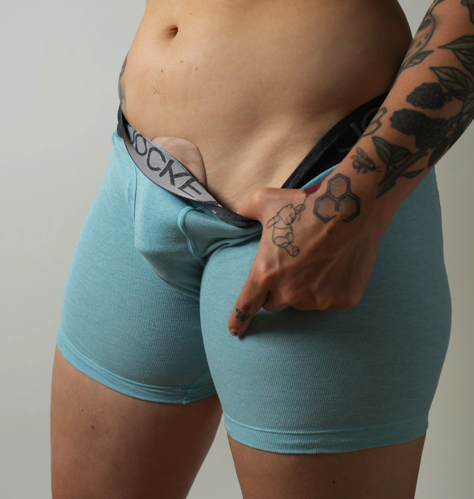 model wearing imprint inside tight blue boxer briefs