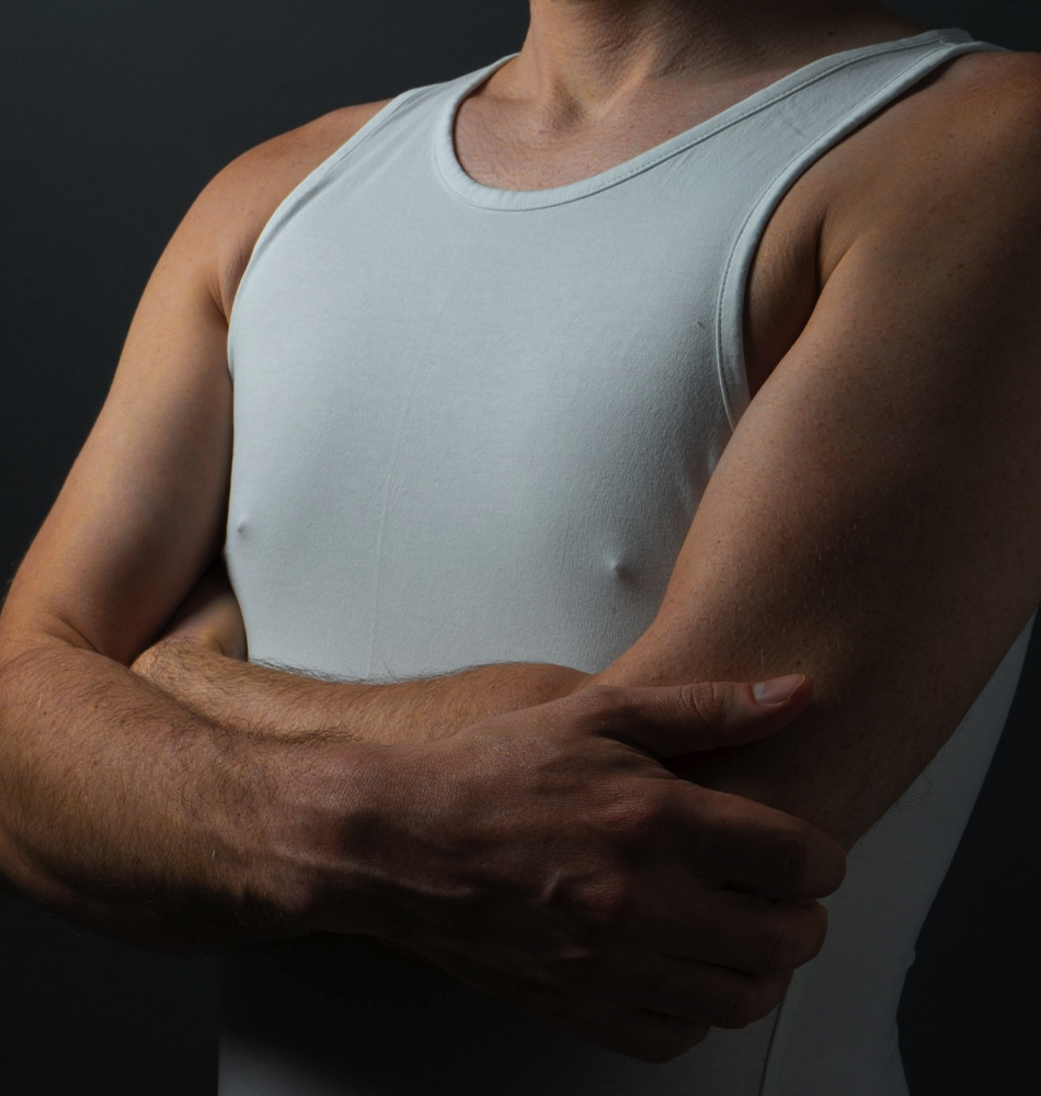 model wearing white tank top showing nipples underneath